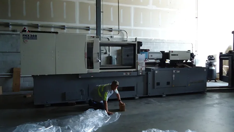 Nissei FNX360 injection molding press on the floor in Palm City, Florida