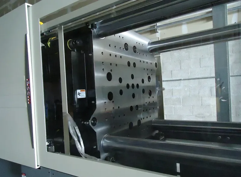 Platen and tie bars on a Nissei press, showing the mold mounting pattern